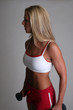 Pretty blond posing with dumbbell