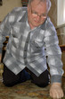 old man standing on his knees