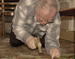 mature man fixes floor