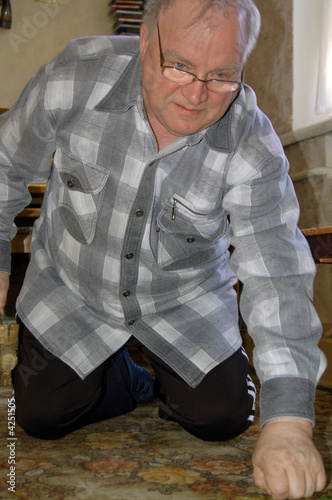 Photo: old man standing on his knees old man standing on his knees