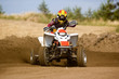 Photo: Young man on quadbike sliding Young man on quadbike sliding