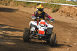 Photo: Young man on quadbike. Young man on quadbike.