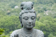 Female statue in front of a temple, providing offerings