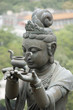 Female statue in front of a temple, providing offerings