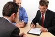 Three business men handling negotiations.