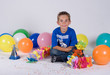 a birthday boy surrounded by balloons