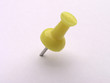 multicolored push pins on white - yellow