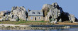 house on island between rocks