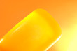 Piece of yellow soap on an orange background