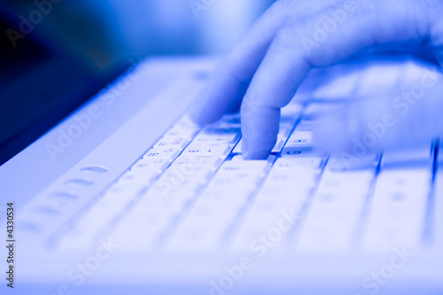 Photo: Closeup of a hand typing on a keyboard Closeup of a hand typing on a keyboard
