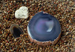 Crystal agat stones on sea-beach background