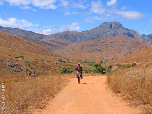 Man walking alone with nude feet on a dirty trackMadagascar