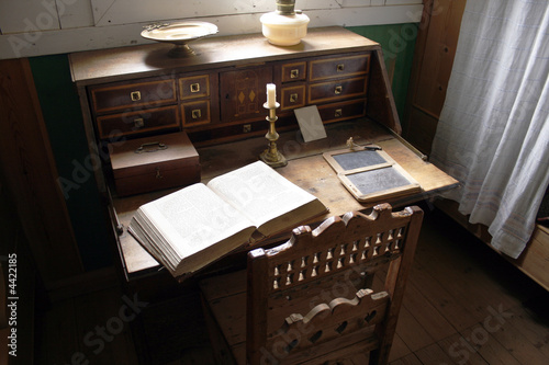 Photo: Very old desk with vintage open bible Very old desk with vintage open bible