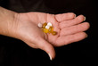 female hand holding pills