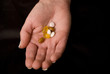 female hand holding pills