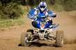 Teenager on a blue quad bike sliding