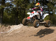 Photo: Teenager jumping on his white quad bike Teenager jumping on his white quad bike