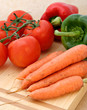 carrots, peppers and tomatoes on chopping board carrots, peppers and tomatoes on chopping board