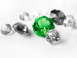 Green gemstone among colorless gemstones