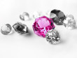 Pink gemstone among colorless gemstones 