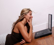 Woman Laughing at her computer