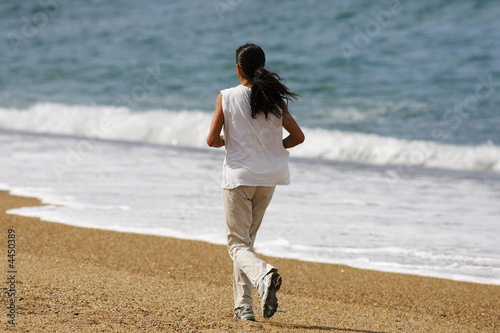 Photo : belle femme qui court au bord de l'eau belle femme qui court au bord de l'eau
