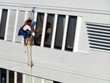 The cleaner who washes a window of the exterior of a yacht