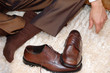 Male brown leather shoes and feet