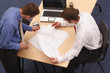 Two architects reviewing the blueprints Two architects reviewing the blueprints