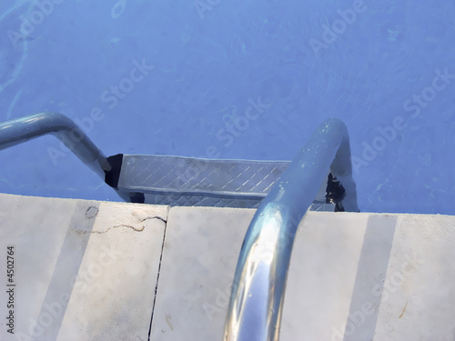 Photo: background with border of pool and stair, with blue calm water background with border of pool and stair, with blue calm water