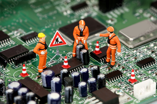 Photo: Technicians working on electronics or motherboard Technicians working on electronics or motherboard