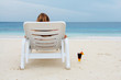 Single woman in calmness. White sand beach.