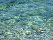 pebbles under a blue surface of sea water