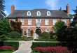 Large house with chimneys, dormers and flowers Large house with chimneys, dormers and flowers