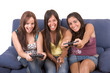Three young smiling women are playing videogames