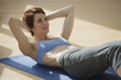 Girl doing situps on an excercise mat Girl doing situps on an excercise mat