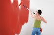 Woman painting on wall