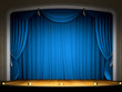Empty stage with blue curtain in expectation of performance