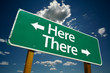 "Here, There" Road Sign with dramatic clouds and sky.