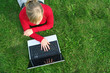 Young woman using laptop outdoors