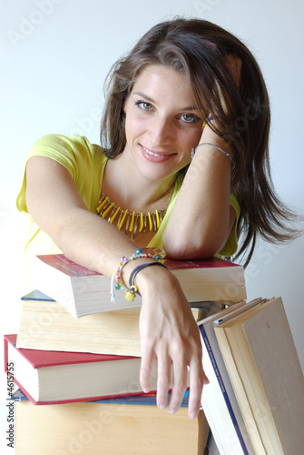 Photo: Girl student and pile of book Girl student and pile of book