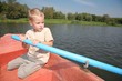 boy on the boat paddling a oar