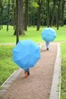 peoples with blue umbrellas in the park