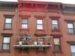 painting the window frames of a townhouse