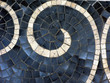 detail of wave depicted with small mosaic pieces on the floor
