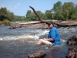 Woman sitting in rapids 2