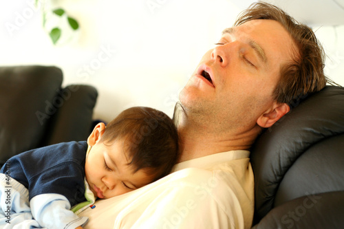 Photo: Father sleeping on chair with his baby boy on chest Father sleeping on chair with his baby boy on chest