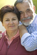 Happy elderly couple embracing outdoors