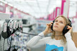 girl listening music with headphones in store girl listening music with headphones in store