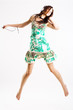 Young female jumping while listening to music